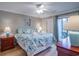 Main bedroom with a king-size bed, coastal bedding, and access to a balcony at 366 Pinehurst Ln. # 13D, Pawleys Island, SC 29585