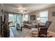 Bright living room with comfy seating, hardwood floors, and sliding glass doors leading to a patio at 366 Pinehurst Ln. # 13D, Pawleys Island, SC 29585