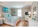 Guest bedroom with a queen-size bed and light, airy decor at 366 Pinehurst Ln. # 13D, Pawleys Island, SC 29585
