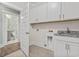 Laundry room with cabinets, sink, and access to a bathroom at 7129 Spoleto Dr., Myrtle Beach, SC 29572