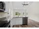 Open kitchen with granite countertops, island, stainless steel appliances, and hardwood floors at 1174 St. John Rd., Galivants Ferry, SC 29544