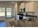 Modern kitchen with stainless steel appliances and dark granite counters at 216 Palmetto Sand Loop, Conway, SC 29527