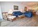 Relaxing living room with two blue sofas, a coffee table, and wicker accent chair at 601 N Hillside Dr. # 2123, North Myrtle Beach, SC 29582