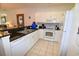 Well-equipped kitchen featuring white cabinetry, granite countertops, and modern appliances at 601 N Hillside Dr. # 2123, North Myrtle Beach, SC 29582