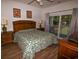 Spacious main bedroom with king-size bed, private balcony, and access to the bathroom at 601 N Hillside Dr. # 2123, North Myrtle Beach, SC 29582
