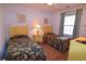 Bedroom with two twin beds, featuring leafy patterned bedding and wood flooring at 601 N Hillside Dr. # 2123, North Myrtle Beach, SC 29582