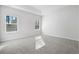 Spacious bedroom with neutral carpeting and two windows at 623 Blackthorne Circle Nw, Calabash, NC 28467