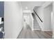 Bright and spacious entryway with wood-look flooring and staircase at 623 Blackthorne Circle Nw, Calabash, NC 28467