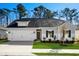 One-story house with gray siding, white trim, and a two-car garage at 623 Blackthorne Circle Nw, Calabash, NC 28467