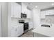 Modern kitchen with stainless steel appliances and white cabinets at 623 Blackthorne Circle Nw, Calabash, NC 28467