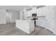 Modern kitchen with white cabinets, quartz countertops, and stainless steel appliances at 623 Blackthorne Circle Nw, Calabash, NC 28467