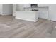 Kitchen with island and gray vinyl plank flooring at 623 Blackthorne Circle Nw, Calabash, NC 28467
