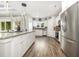 Modern kitchen featuring white shaker cabinets, stainless steel appliances, and hardwood floors at 1886 Southwood Dr., Myrtle Beach, SC 29575