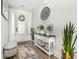 Bright and airy entryway with a console table, plants, and a comfortable bench at 1886 Southwood Dr., Myrtle Beach, SC 29575