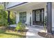 Inviting front porch with black front door, potted plants, and a stylish wreath at 1886 Southwood Dr., Myrtle Beach, SC 29575