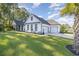 White house with black windows, a three-car garage, and a spacious green lawn at 1886 Southwood Dr., Myrtle Beach, SC 29575
