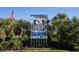 North Myrtle Beach welcome sign with palm trees and American flag at 1000 Strand Ave., North Myrtle Beach, SC 29582