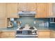 White stovetop and teal countertops in this well-lit kitchen at 1000 Strand Ave., North Myrtle Beach, SC 29582