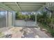 Relaxing patio area with a wooden swing bench, offering a peaceful backyard view at 1000 Strand Ave., North Myrtle Beach, SC 29582
