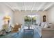 Bright living room with balcony access and wicker furniture at 1000 Strand Ave., North Myrtle Beach, SC 29582