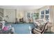 Bright living room featuring a sofa, rocking chairs, and large windows at 1000 Strand Ave., North Myrtle Beach, SC 29582
