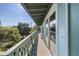 Long deck overlooking trees with a partial ocean view at 1000 Strand Ave., North Myrtle Beach, SC 29582