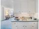 Small kitchen with white cabinets and a light teal countertop at 1000 Strand Ave., North Myrtle Beach, SC 29582