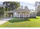 Gray house with white trim, carport, and a spacious yard at 1210 John St., Mullins, SC 29574