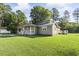 Gray house with white trim and a large grassy yard at 1210 John St., Mullins, SC 29574