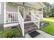Front porch with white railings and red chairs at 1210 John St., Mullins, SC 29574