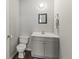 Simple bathroom with vanity, toilet, and dark flooring at 1210 John St., Mullins, SC 29574
