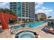Large pool and hot tub surrounded by lounge chairs at 107 S Ocean Blvd. # 1908, Myrtle Beach, SC 29577