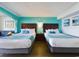 Bedroom with two double beds and teal colored walls at 6900 N Ocean Blvd. # 410, Myrtle Beach, SC 29572