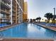 Large resort swimming pool with lounge chairs at 6900 N Ocean Blvd. # 410, Myrtle Beach, SC 29572