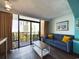 Living room with sofa, coffee table, and balcony access at 6900 N Ocean Blvd. # 410, Myrtle Beach, SC 29572