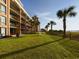 Resort building exterior with grassy area at 6900 N Ocean Blvd. # 410, Myrtle Beach, SC 29572