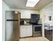 Small kitchen with stainless steel appliances and white cabinets at 6900 N Ocean Blvd. # 410, Myrtle Beach, SC 29572
