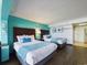 Bedroom with two double beds and teal colored walls at 6900 N Ocean Blvd. # 410, Myrtle Beach, SC 29572
