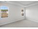 Bright bedroom with neutral walls, carpet, and two large windows offering natural light at 3030 Deerberry Place, Longs, SC 29568