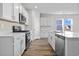 Modern kitchen featuring white cabinets, quartz countertops, and stainless steel appliances at 3030 Deerberry Place, Longs, SC 29568