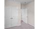 Spacious bedroom with double doors leading to another room and a large closet at 3042 Deerberry Place, Longs, SC 29568