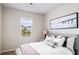 Cozy bedroom with a queen bed, window, and beach-themed wall art at 3042 Deerberry Place, Longs, SC 29568