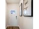 Bright entryway with white door, wood floor, and modern wall art at 3042 Deerberry Place, Longs, SC 29568