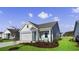 Newly built home with light blue siding, two-car garage, and a well-manicured lawn at 3042 Deerberry Place, Longs, SC 29568
