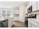 Modern kitchen with white cabinets, stainless steel appliances and island at 3042 Deerberry Place, Longs, SC 29568