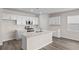 Modern kitchen with white cabinets, island and stainless steel appliances at 3042 Deerberry Place, Longs, SC 29568