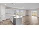 Open concept kitchen with island and view into living area at 3042 Deerberry Place, Longs, SC 29568