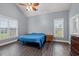 Bright bedroom with wood-look floors, ceiling fan, and two windows at 3712 Faith Dr., Conway, SC 29527