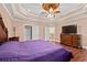 Main bedroom with tray ceiling, hardwood floors, and access to bathroom at 3712 Faith Dr., Conway, SC 29527