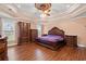 Main bedroom with tray ceiling, hardwood floors, and ample furniture at 3712 Faith Dr., Conway, SC 29527